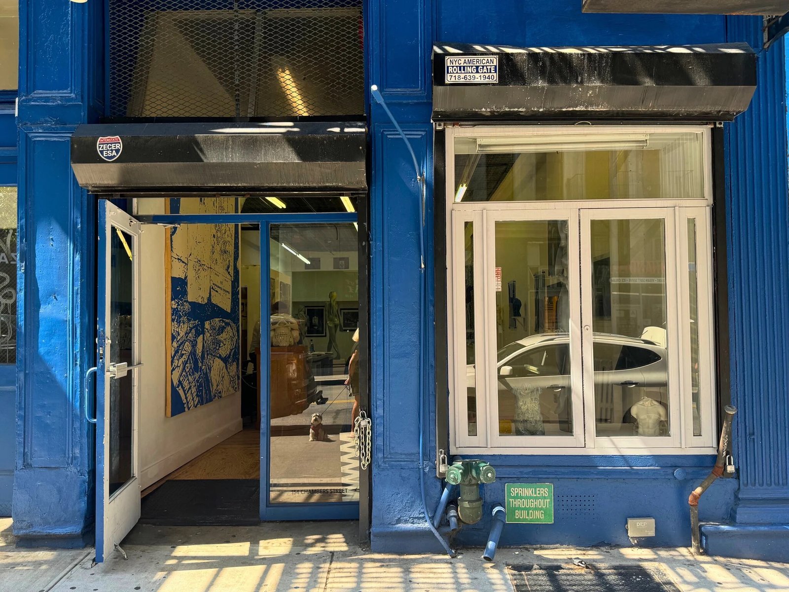 Blue street-level storefront and clear front windows at 154 Chambers Street